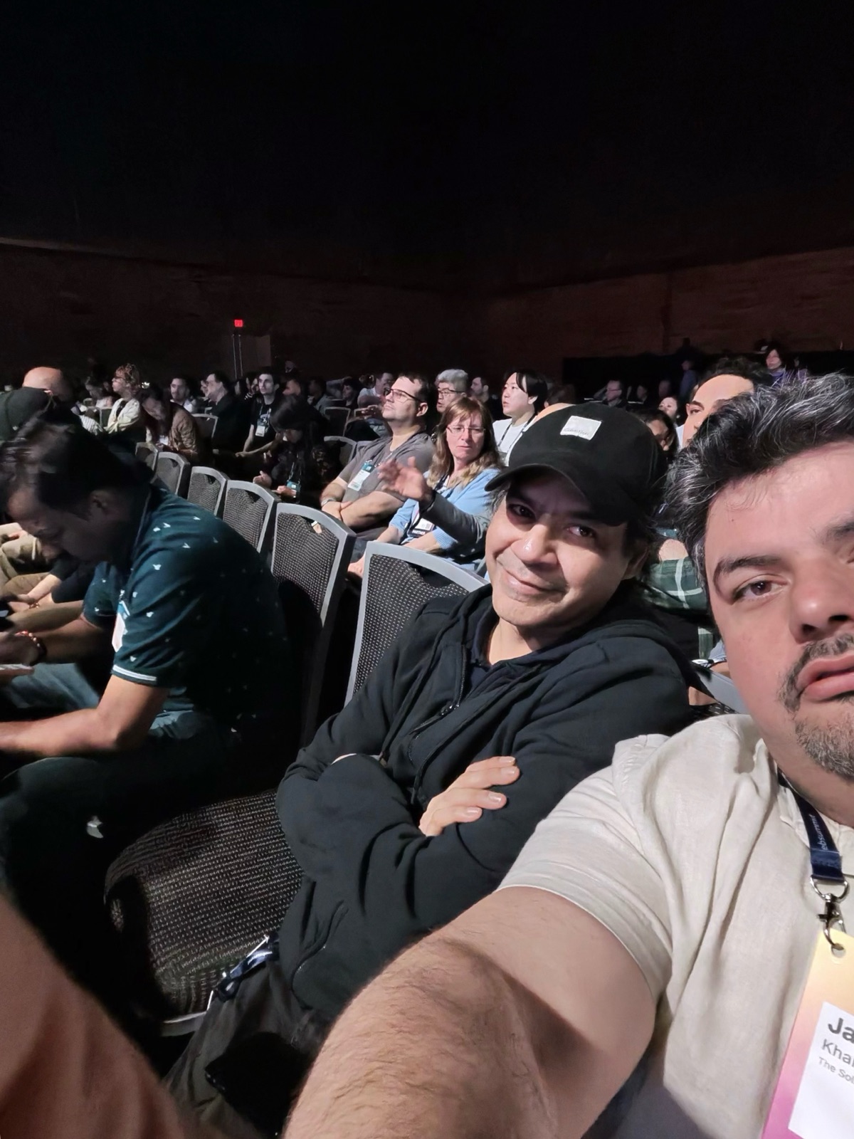 Nasir Teherany (foreground) and Jawad Khalil (in cap) listening from the floor at a Web Summit Vancouver keynote.
